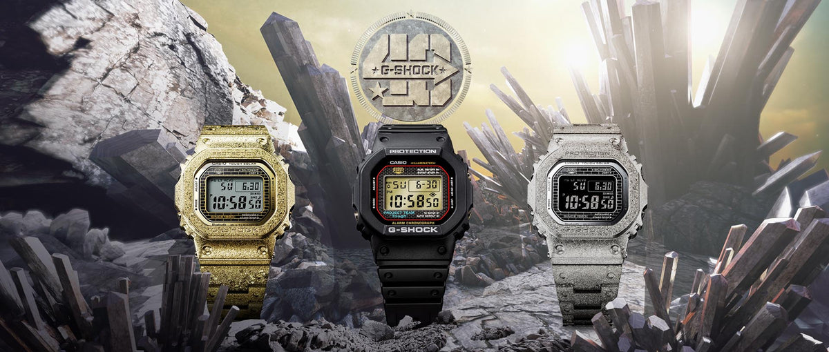 Three G-SHOCK Recrystallized series watches in gold, black, and silver displayed against a jagged crystal rock background.