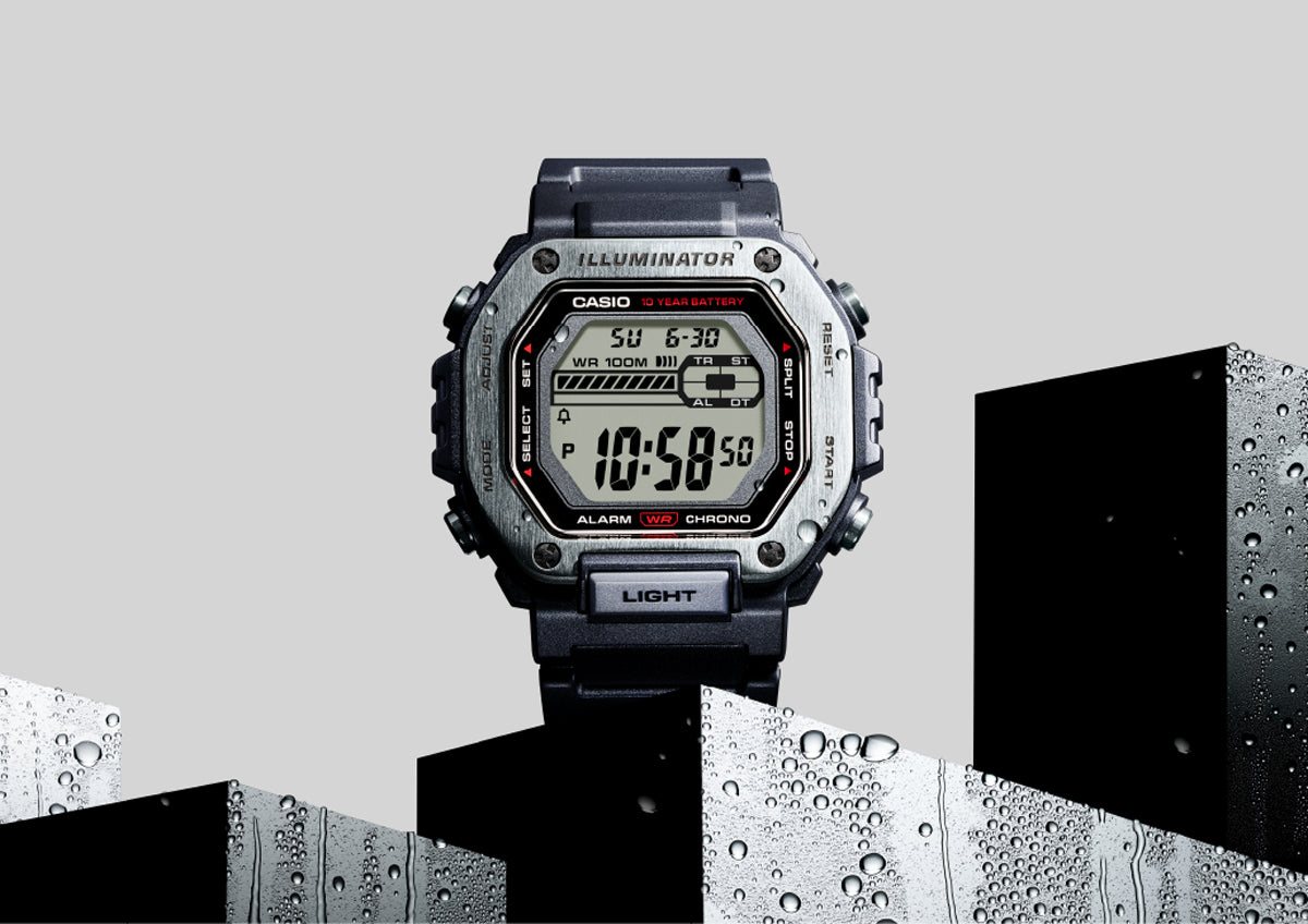 Casio MWD-110H digital watch with a metallic bezel and black resin strap set against wet, geometric blocks.