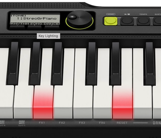 Close-up of a digital keyboard with illuminated red keys, a black control panel, and a digital display screen.