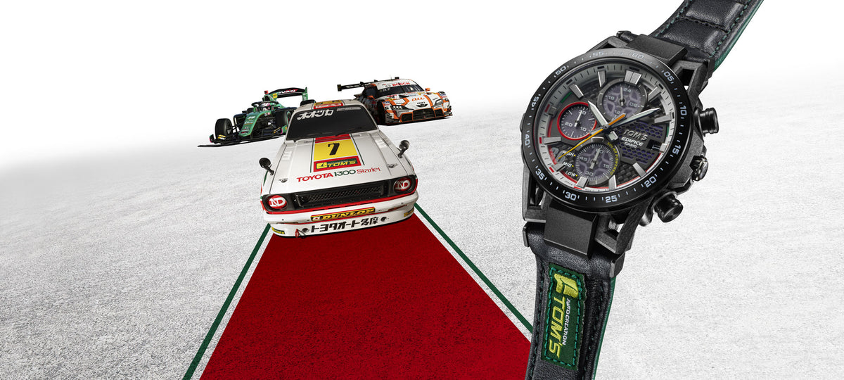Casio Edifice TOM'S 50th anniversary watch with a black leather strap alongside vintage and modern TOM'S racing cars.