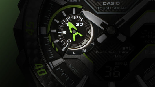 Close-up of a Casio Tough Solar watch face featuring a bright green indicator dial and textured black metallic details.