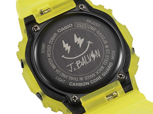 Close-up of a Casio G-Shock DWE-5600JB watch back featuring a J Balvin smiley face logo and neon yellow translucent strap.