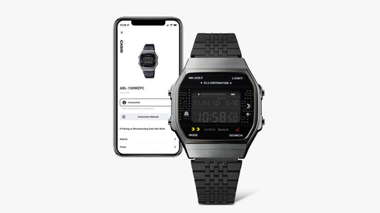 Casio ABL-100WEPC digital watch with a Pac-Man design next to a smartphone displaying the connected Casio app.