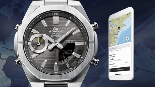 Casio Edifice watch with a textured grey dial and digital display paired with a smartphone showing a map app.