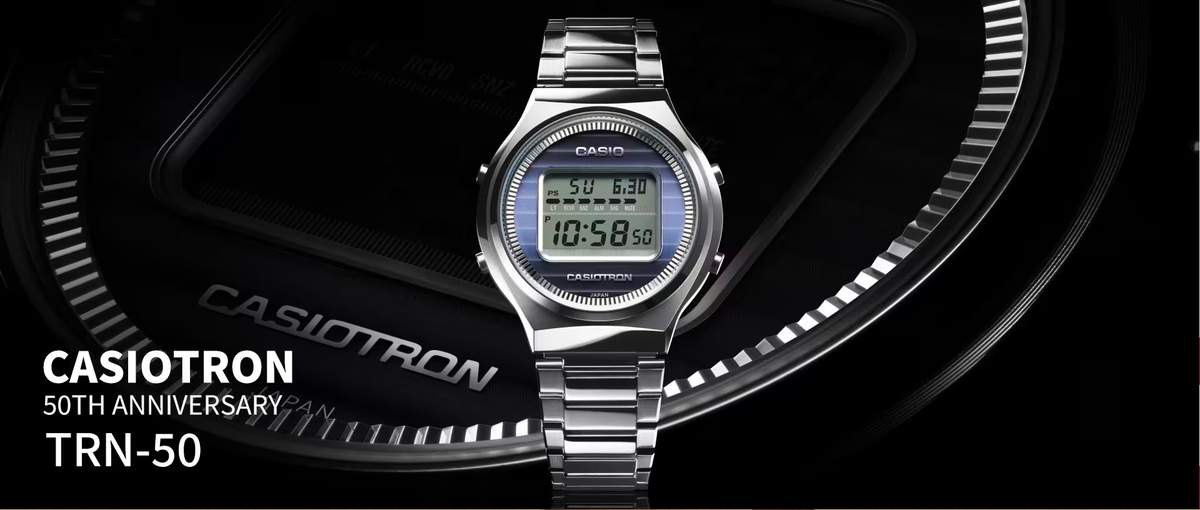 Silver Casiotron TRN-50 50th anniversary digital watch with a blue striped dial on a metallic link bracelet.