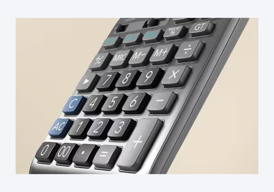 Close-up of a modern desktop calculator with black, square-shaped keys and a sleek, dark grey metallic finish.