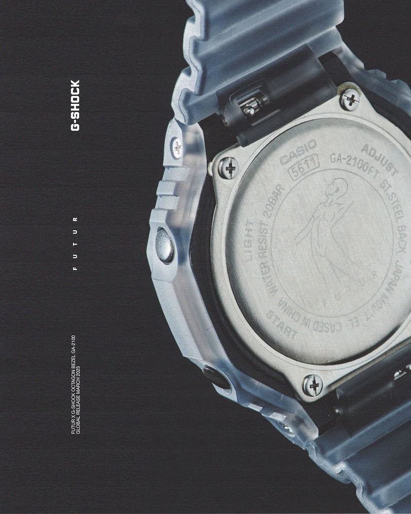 Close-up of a translucent blue G-Shock GA-2100 watch case back with engraved branding and a figure illustration.