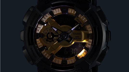 Casio G-Shock watch with a black resin bezel and a metallic gold analog-digital dial featuring luminous hands.