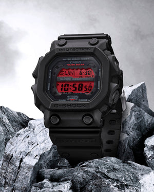 Digital watch with red display on rocky terrain