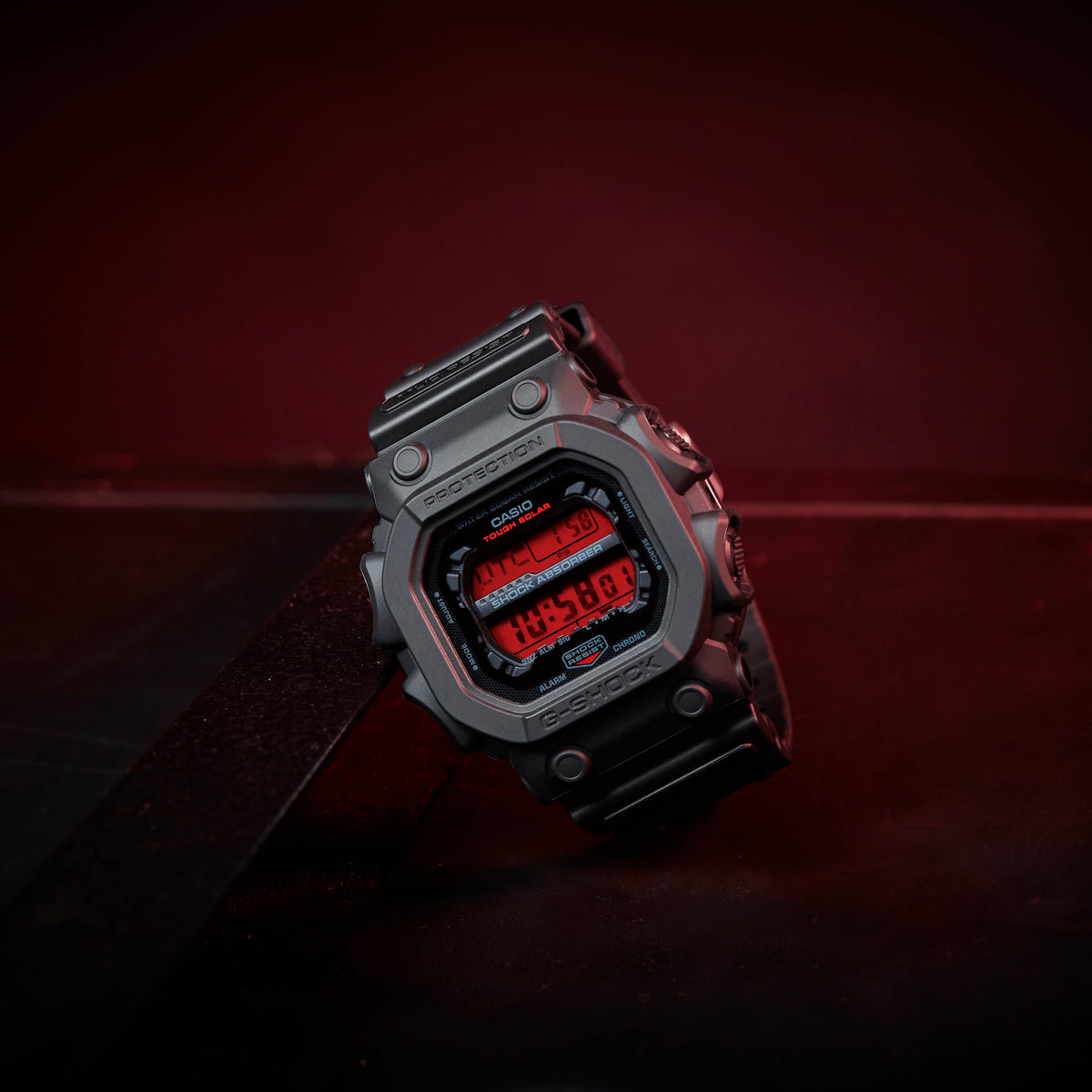 Digital watch with red display on a dark background