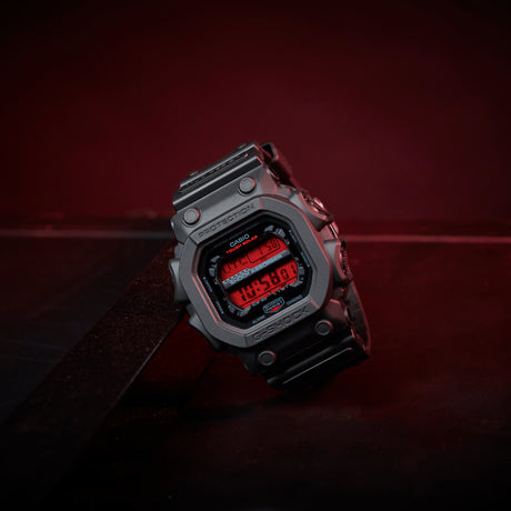 Digital watch with red display on a dark background