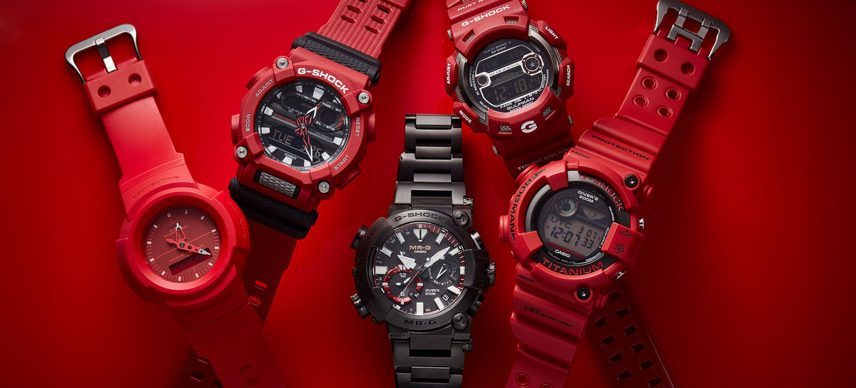 Collection of red and black Casio G-SHOCK watches arranged on a vibrant red background.