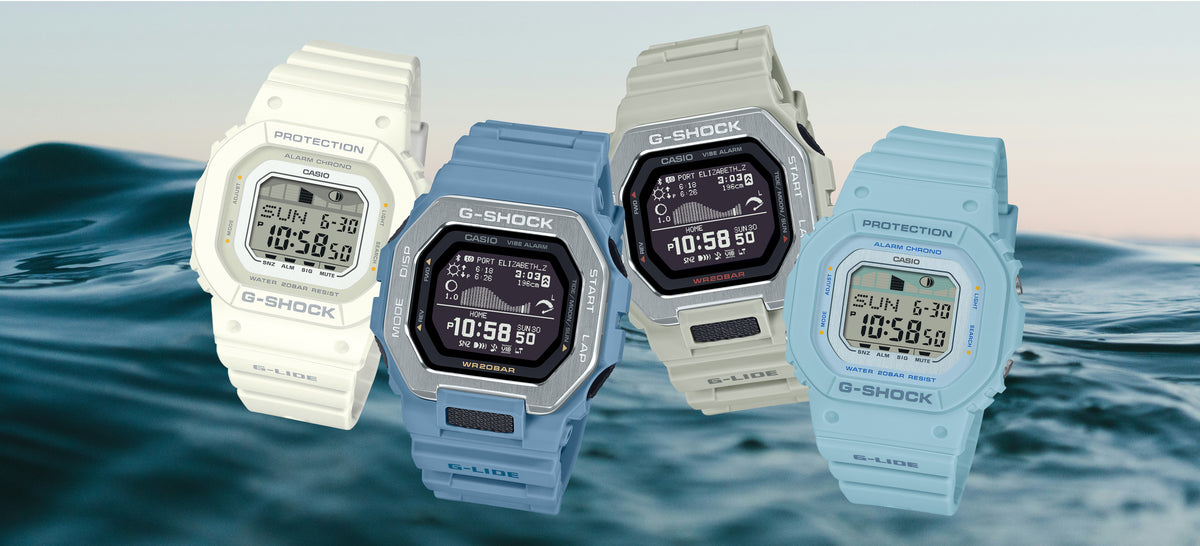Four Casio G-Shock G-LIDE digital watches in white, blue, and beige against a blurred ocean wave background.