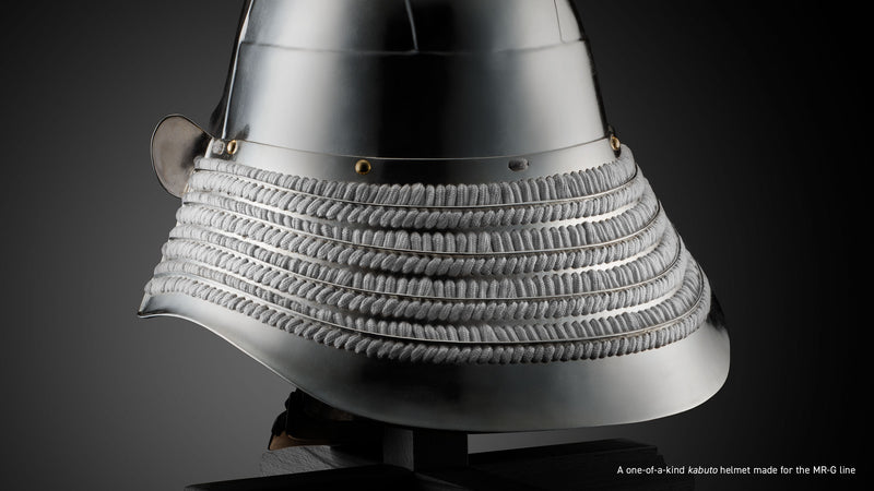 Polished silver kabuto helmet featuring layered metal plates and intricate white cord lacing on a dark background.