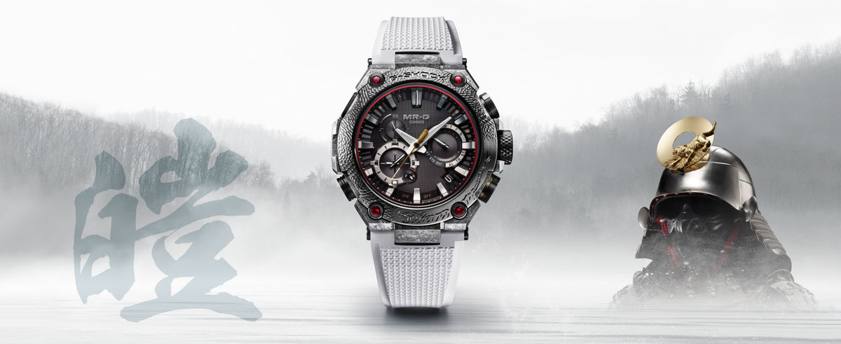 Casio G-SHOCK MR-G watch with a textured silver bezel, white band, and red accents beside a traditional samurai helmet.