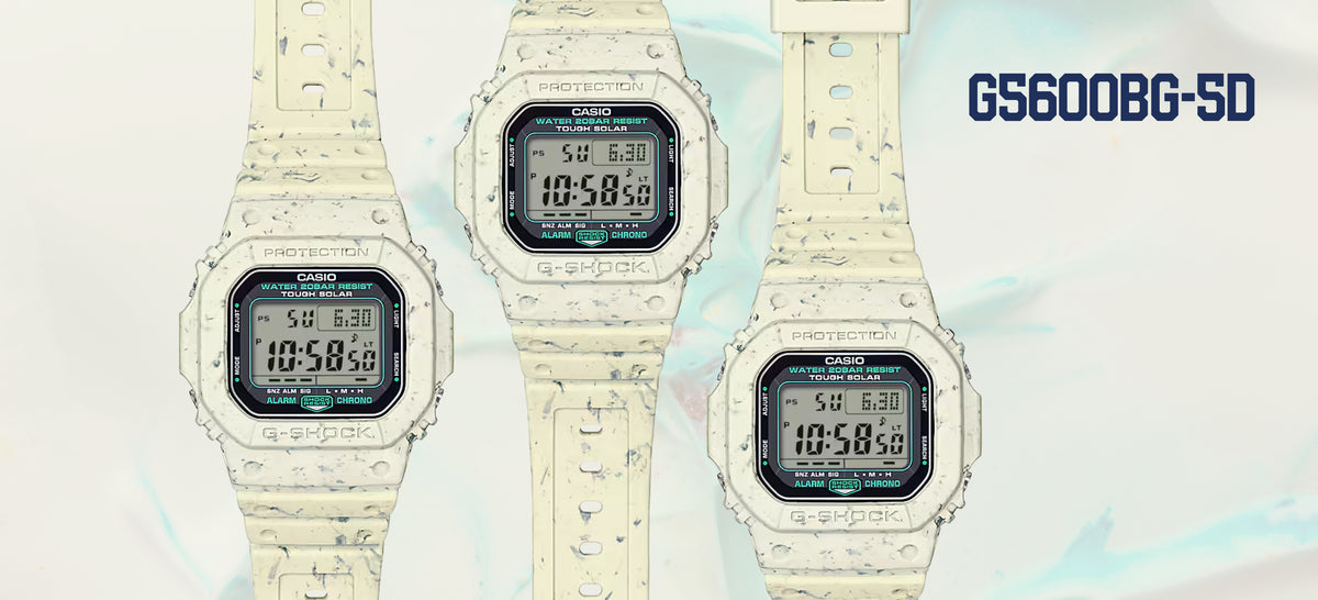 Three G-Shock G5600BG-5D watches with a cream-colored, speckled resin finish and digital displays on a marbled background.