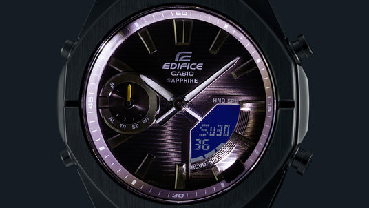 Close-up of a black Casio Edifice watch face with a textured dial, luminous hands, and a digital blue LCD display.
