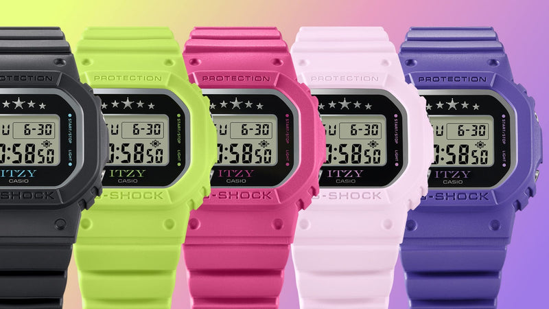 Five Casio G-Shock ITZY digital watches in black, lime green, hot pink, light pink, and purple against a gradient background.