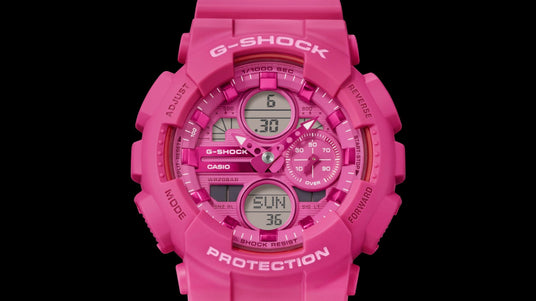 Bright pink G-Shock analog-digital watch with a rugged resin case, metallic accents, and a black background.