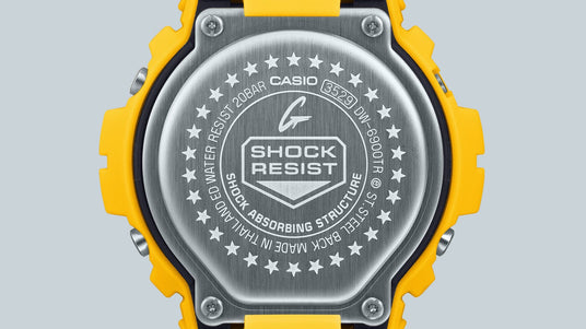 Stainless steel case back of a yellow G-Shock watch featuring engraved branding, model number, and star detailing.