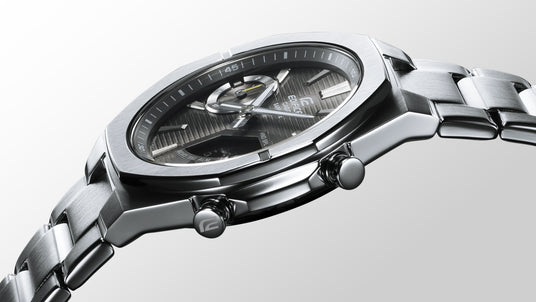 Close-up of a Casio Edifice stainless steel watch with a textured black dial and metallic link bracelet.