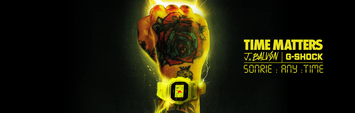 Tattooed fist wearing a glowing yellow J Balvin G-Shock watch against a dark background with lightning effects.