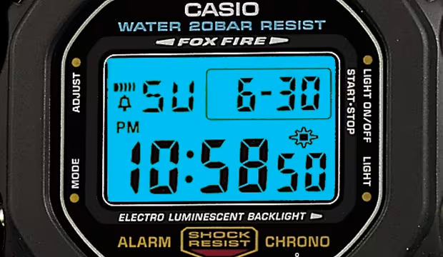 Close-up of a Casio G-Shock digital watch face with a bright blue electroluminescent backlight display.